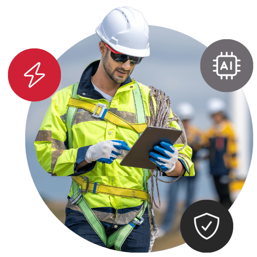 A construction worker looking down at a clipboard.